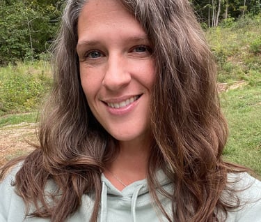 a woman with long hair and a green hoodie