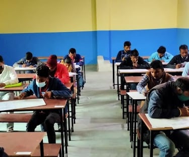 a classroom with many students sitting at desks