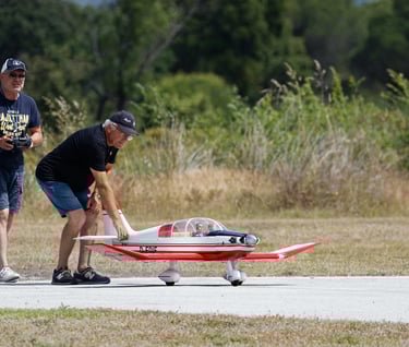 Two men ready to fly an RC airplane.
