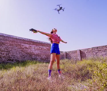 Woman in a filed flying a drone.