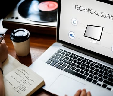 a person with a notebook with a laptop on it