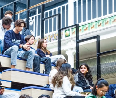 a group of people sitting on a bench in Albert School