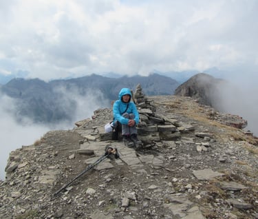 a person sitting on a mountain top