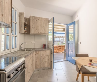 a kitchen with a table and chairs 