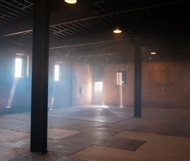 Spacious industrial warehouse loft at Grayfox Studios with exposed brick walls, beams, and natural