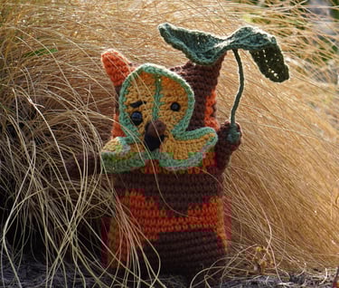 A korok holding a leaf standing in a bush.