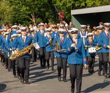a bandleader in blue uniforms marching the band