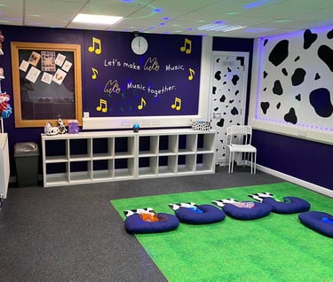 The moo room with the seat set up for class, walls to show the moo slogan, gift shop and cow print.