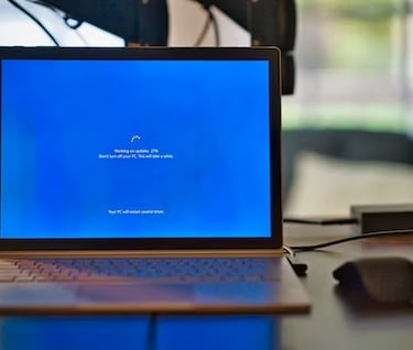 a laptop computer with a blue screen and a mouse