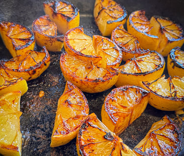 Lemon wedges grilled in a cast iron skillet