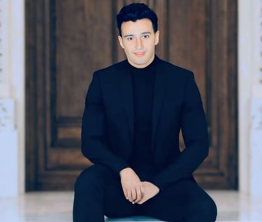 a man in a suit and black shirt