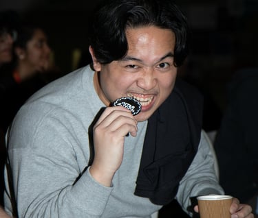 Candid event portrait of a guest enjoying food at an indoor event