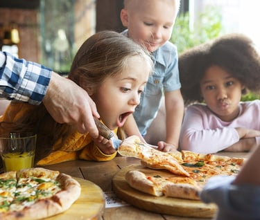 a family eating pizzas at a restaurant