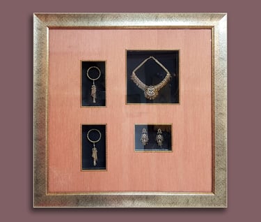 A uniquely customized shadow box frame displaying antique jewelries