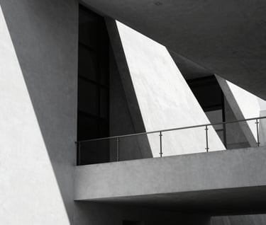 Abstract black and white architectural detail of a modern cultural center in Mexico. Strong play of light and shadow on white walls, reflecting a minimalist and contemporary aesthetic.