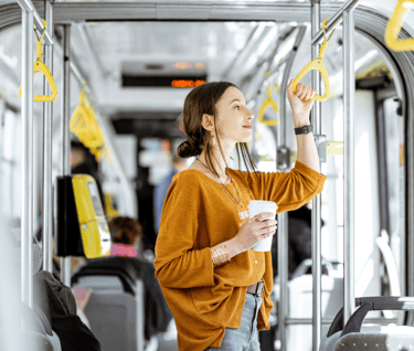 a woman in a yellow sweater is holding a cup of coffee