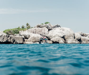 a person is surfing on a large rock formation