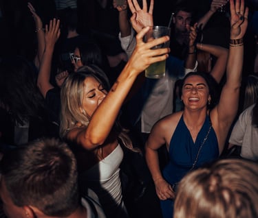 a woman in a white dress is dancing at a party