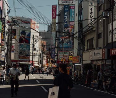 a man walking down a street with a skateboard