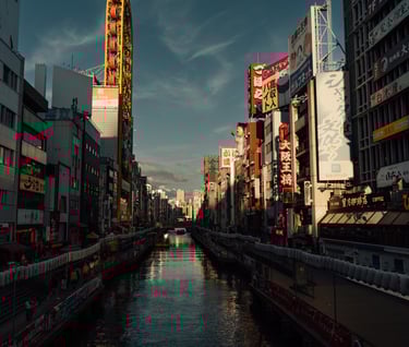 a city street scene with a river running through a city