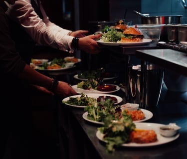 a man is serving food to a woman in a restaurant