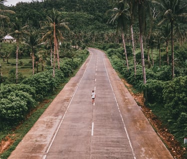 a person riding a bike down a road