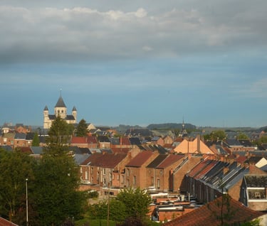a church steeple with a clock tower in the background