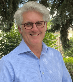 a man in a blue shirt and glasses