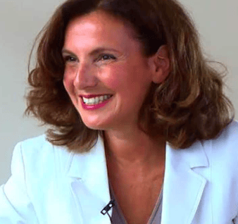 a woman in a white jacket and a white shirt