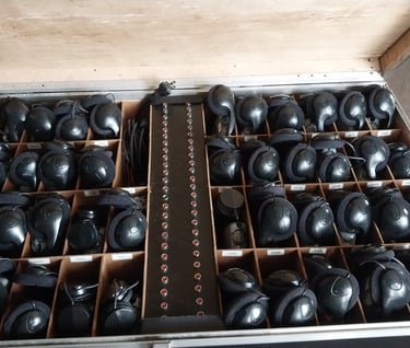 a suitcase with many different types of headphones