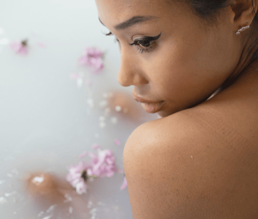 a young girl in a bathtub with flowers