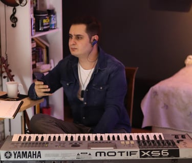 a man sitting at a desk with a keyboard and a keyboard