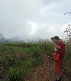a man in a field with fog and overcast conditions deep in thought