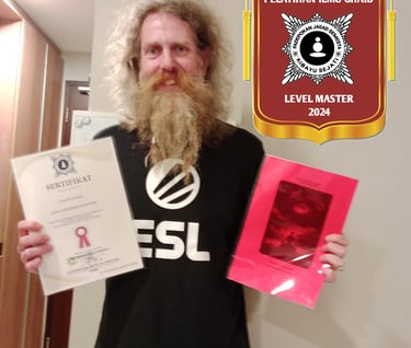 a man holding up a certificate of qualification in the Supernatural Sciences of the Universe and a workbook