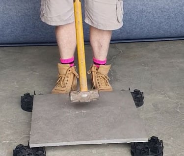 Hitting tile with sledgehammer