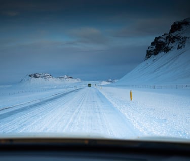 a car driving down a snowy road