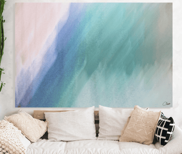 Abstract canvas prints on wall above couch with cushions
