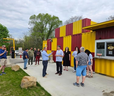 Bright red and yellow HeckYA shipping container drive-through restaurant on McCartney Rd Youngstown