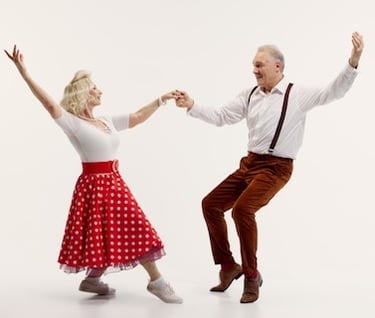 a man and woman dancing in a dance pose