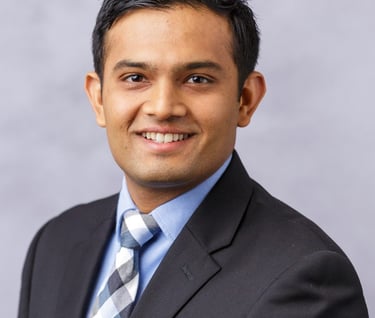 a man in a suit and tie smiling