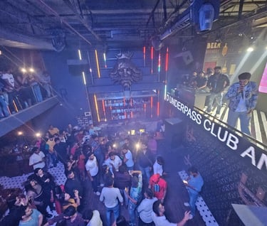 a group of people standing around a bar