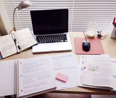a laptop computer sitting on a desk with a laptop and a mouse