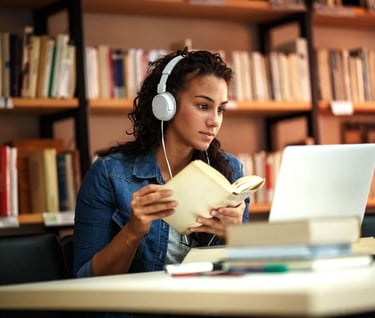 a woman in headphones and headphones is sitting at a desk