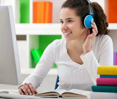 a woman in headphones and headphones is sitting at a desk