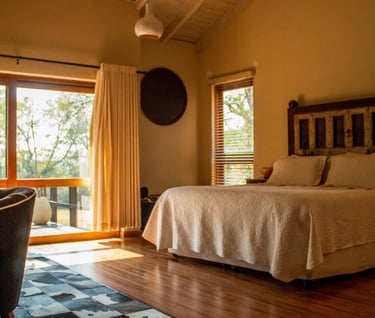 a bedroom with a bed and a chair
