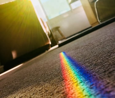 a rainbow - colored rainbow - colored light shining through a rainbow - colored light