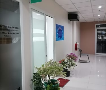 a hallway with a lot of plants and a sign