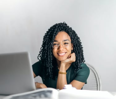 a woman with glasses and a laptop computer