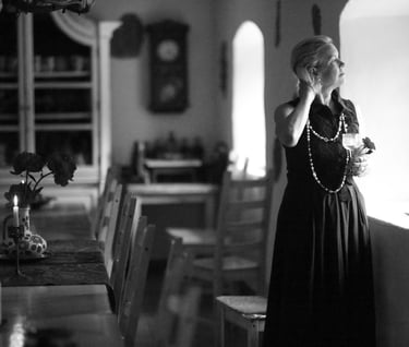 a woman in a long dress standing in a room