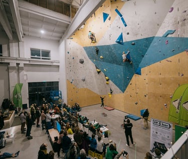 a group of people lead climbing in front of a crowd